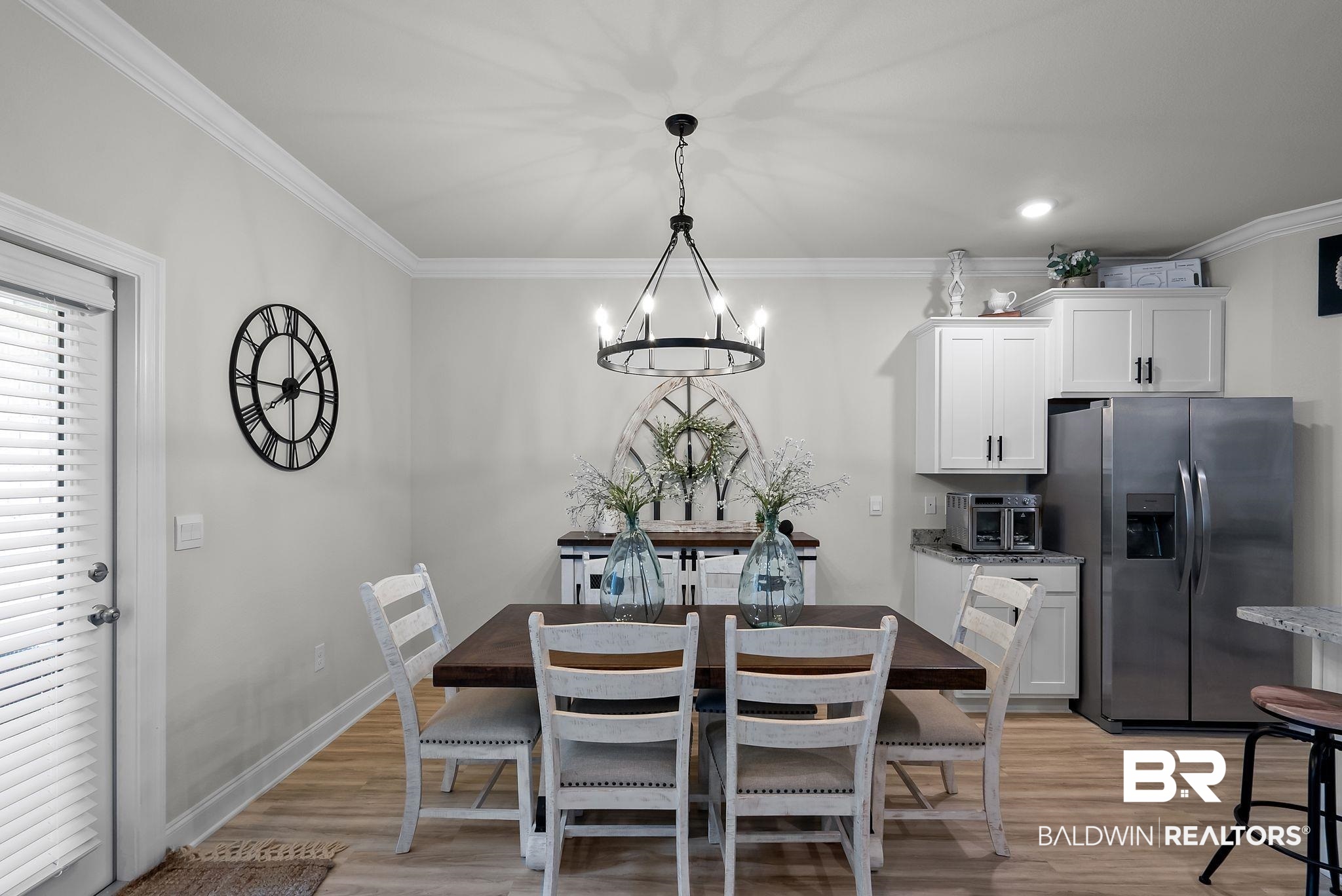 13966 Antler Hl Road Daphne, AL 36527 - Photo 9 of 44 Dining area with wood-finish flooring, crown molding, and a modern chandelier
