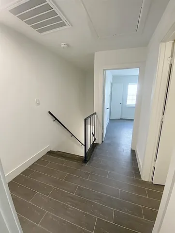 a view of a hallway with stairs