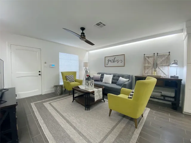 a living room with furniture and a rug