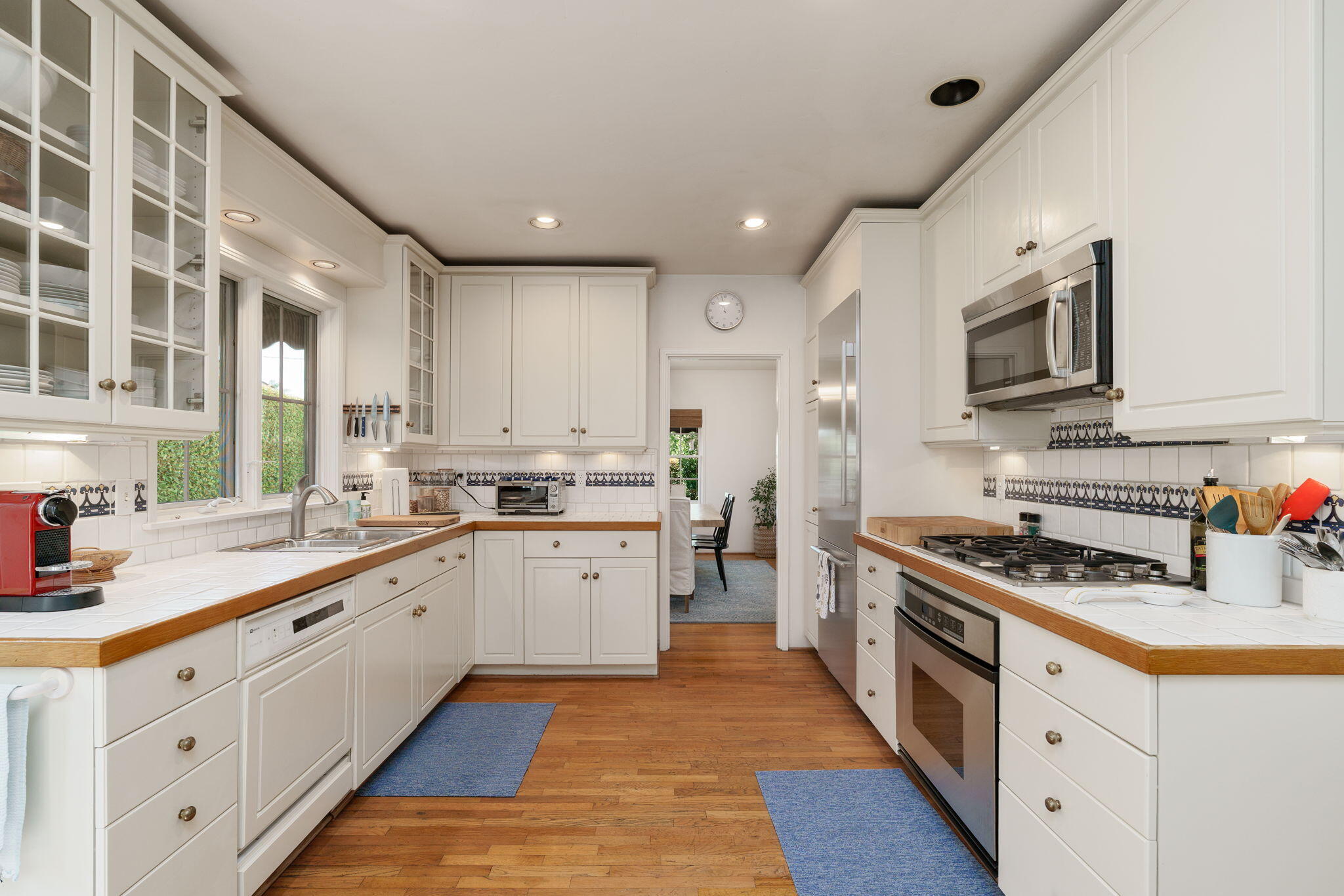 2228 Chapala Street Santa Barbara, CA 93105 - Photo 11 of 31 a kitchen with stainless steel appliances sink stove microwave and cabinets