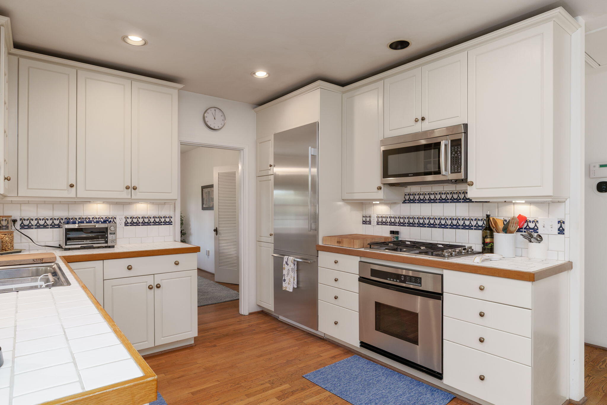 2228 Chapala Street Santa Barbara, CA 93105 - Photo 12 of 31 a kitchen with stainless steel appliances a stove microwave and cabinets