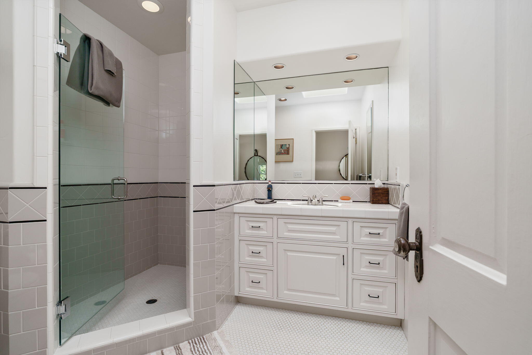 2228 Chapala Street Santa Barbara, CA 93105 - Photo 15 of 31 a bathroom with a shower sink and mirror