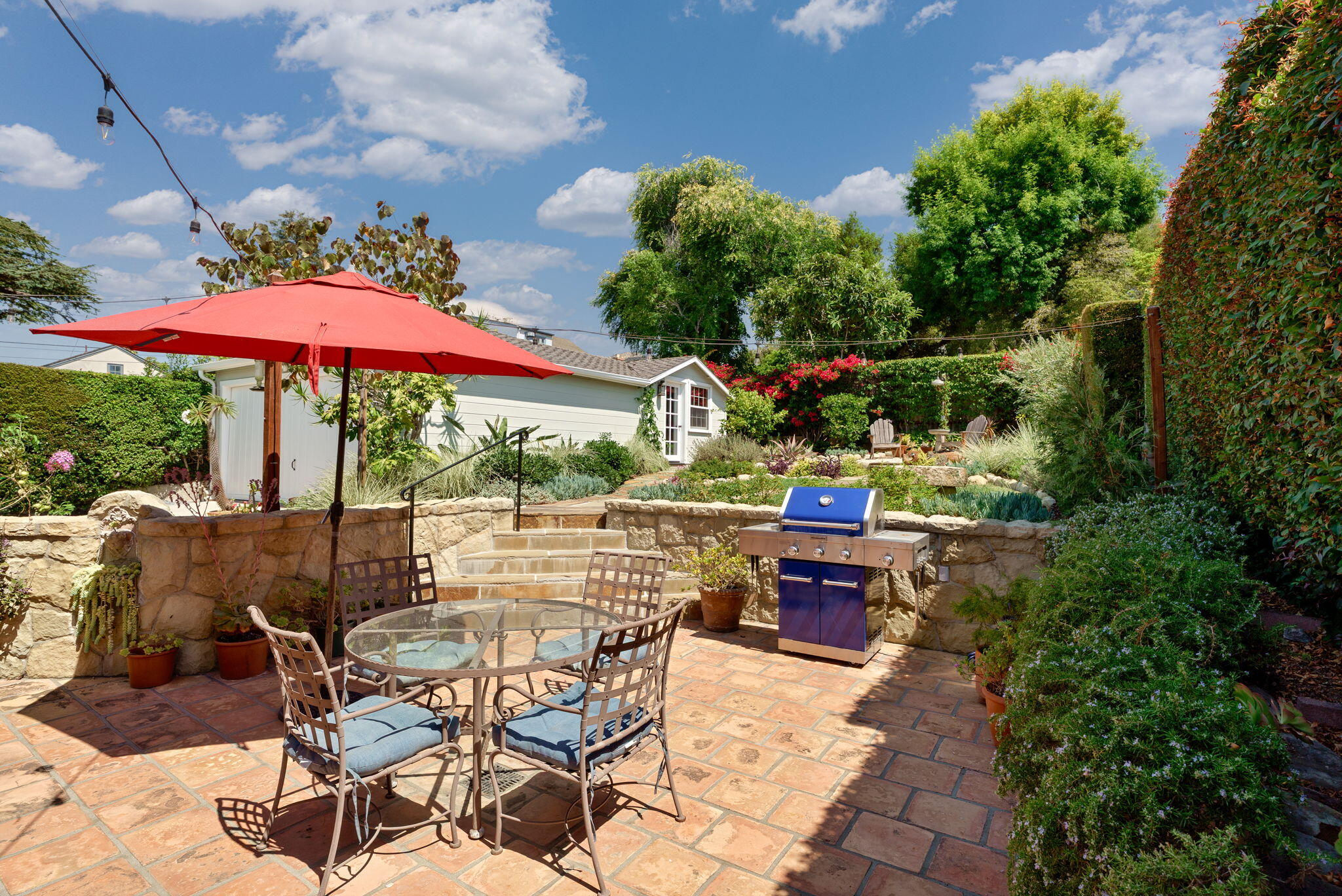 2228 Chapala Street Santa Barbara, CA 93105 - Photo 26 of 31 a view of a patio with table and chairs under an umbrella