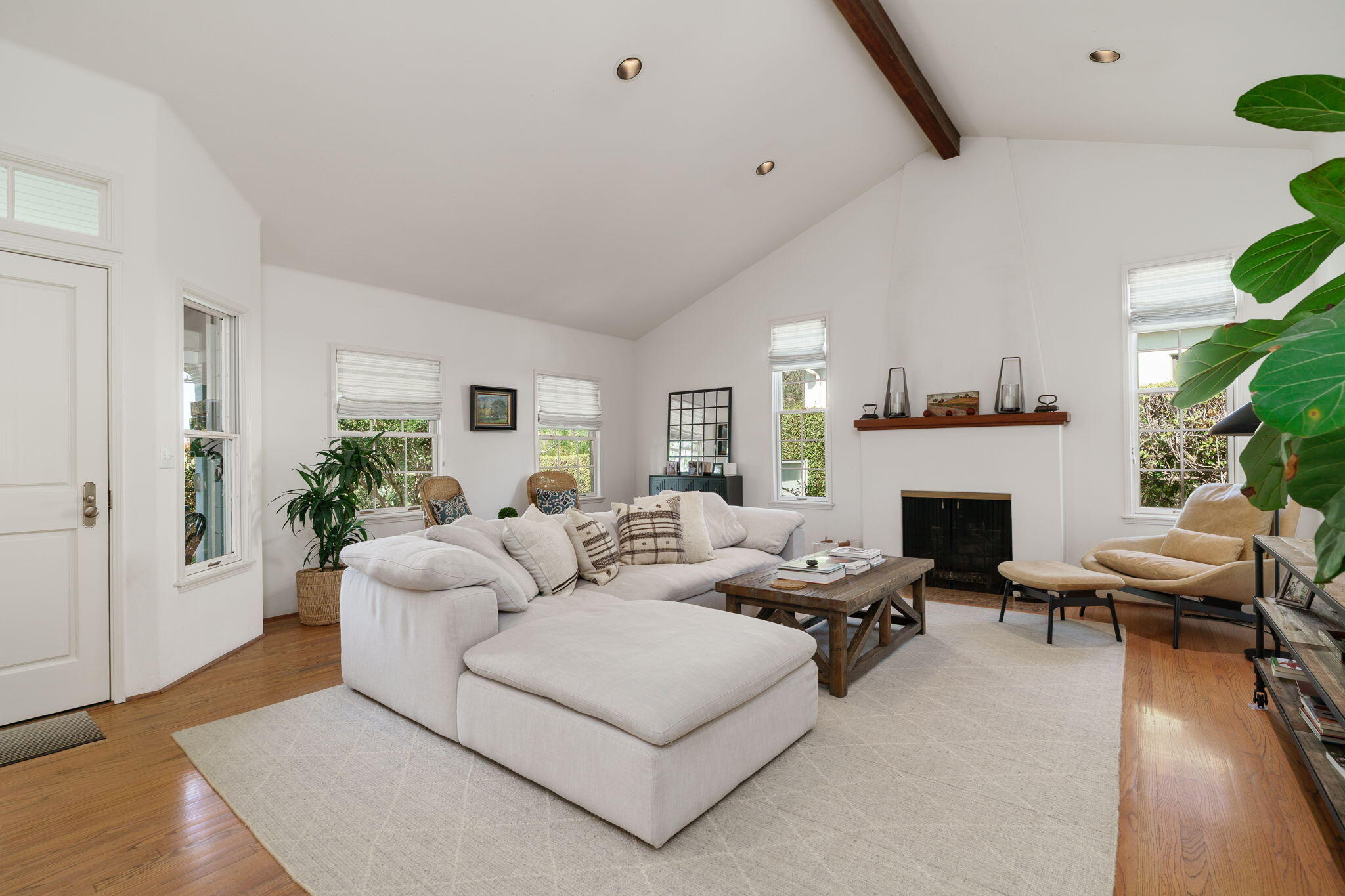 2228 Chapala Street Santa Barbara, CA 93105 - Photo 6 of 31 a living room with furniture a fireplace and a potted plant