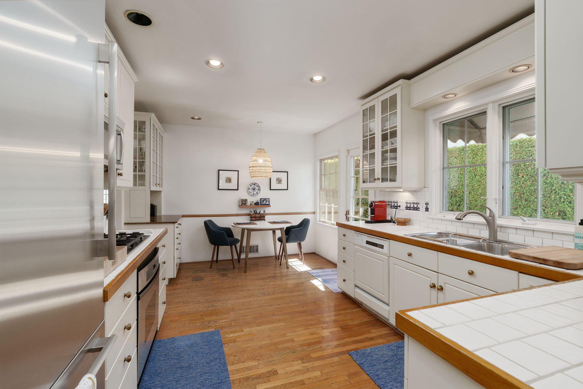 2228 Chapala Street Santa Barbara, CA 93105 - Photo 9 of 31 a large white kitchen with lots of counter space and glass door