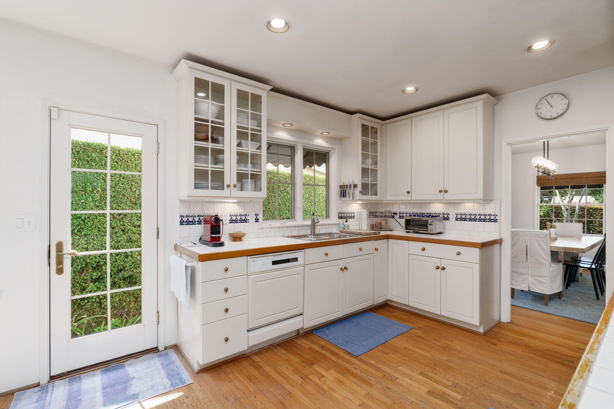 2228 Chapala Street Santa Barbara, CA 93105 - Photo 10 of 31 a kitchen with sink cabinets and wooden floor