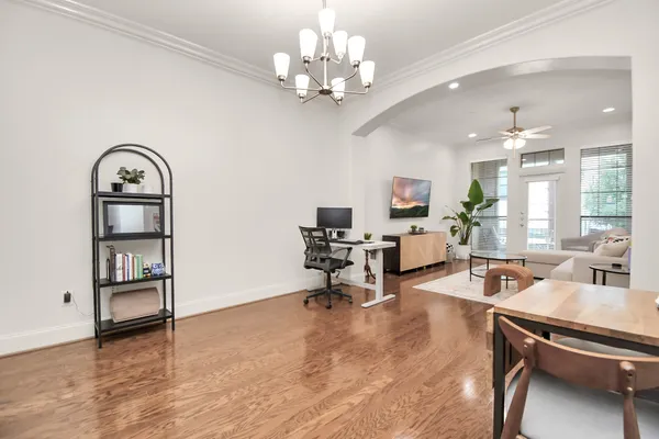 a view of a livingroom with workspace and a window