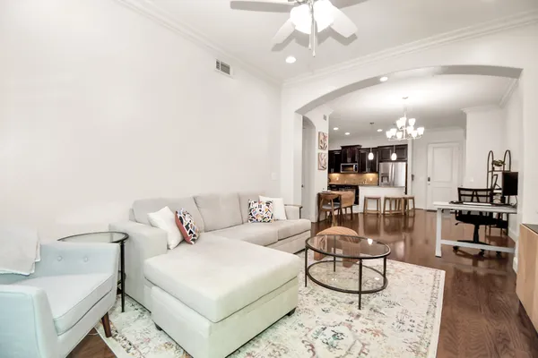 a living room with furniture and wooden floor