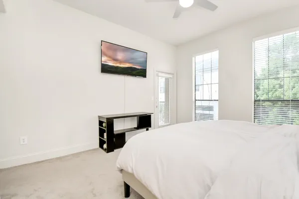 a bedroom with a bed and a tv