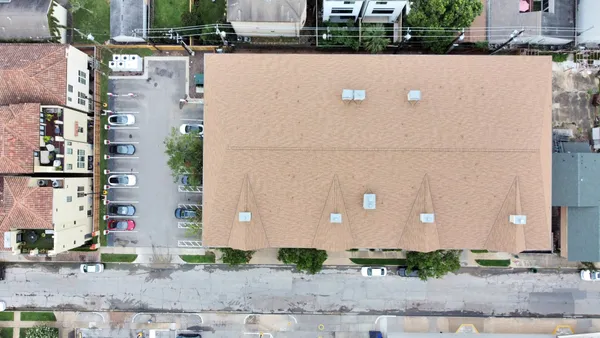 an aerial view of residential house with outdoor space and parking