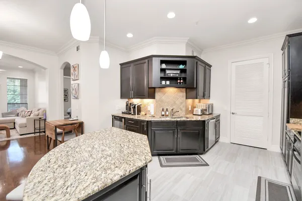 a kitchen with stainless steel appliances granite countertop a stove and a sink