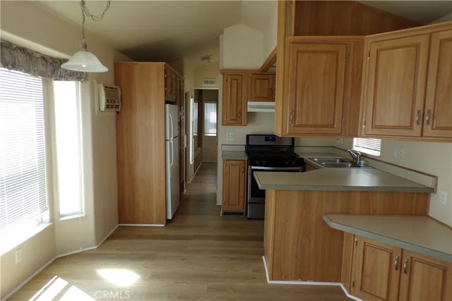 a kitchen with stainless steel appliances a refrigerator and a stove