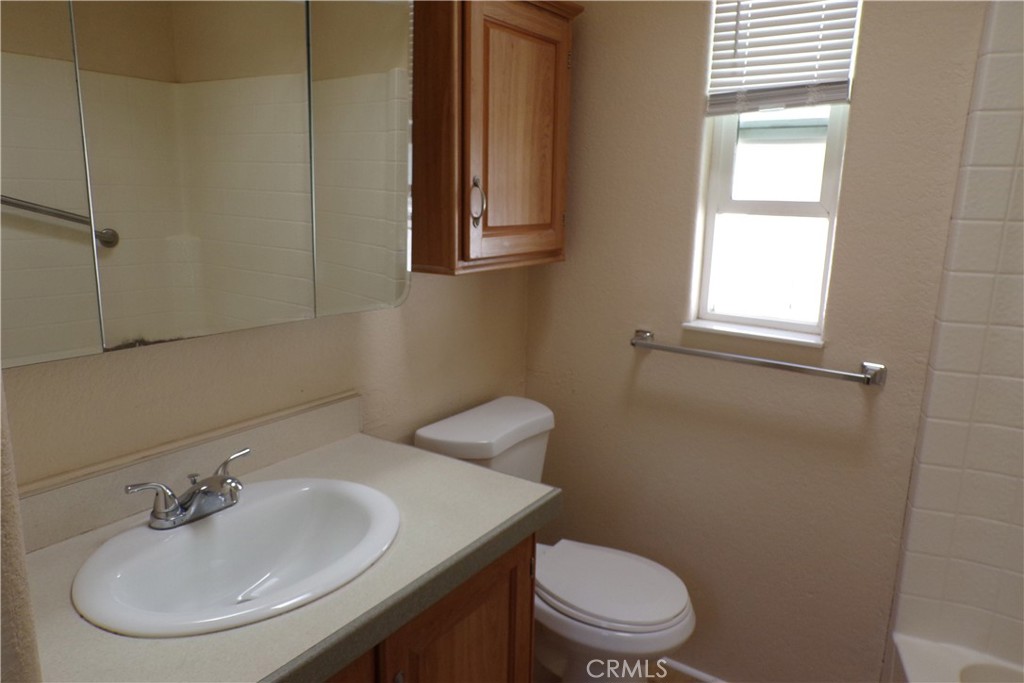 12710 3rd Street, Unit 98 Yucaipa, CA 92399 - Photo 6 of 10 a bathroom with a sink a toilet and a mirror