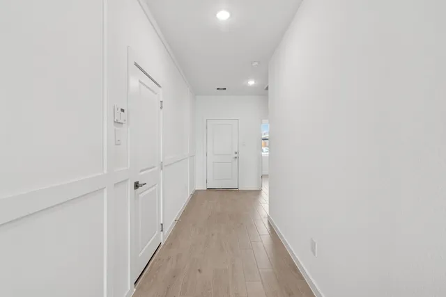 a view of a hallway with wooden floor
