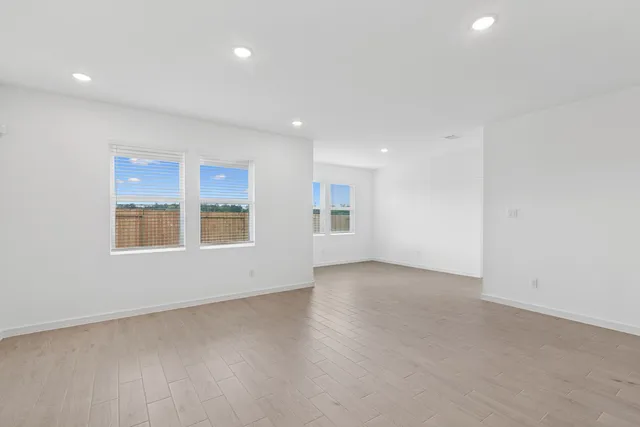 an empty room with a empty space and windows