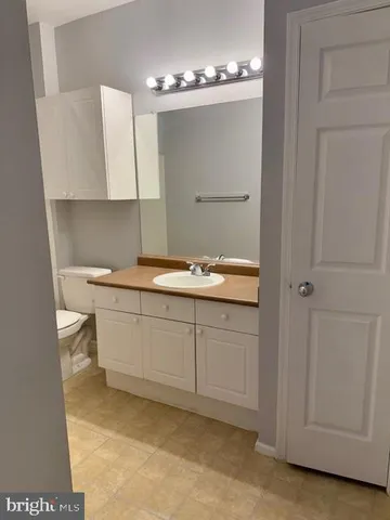 a bathroom with a sink vanity and mirror