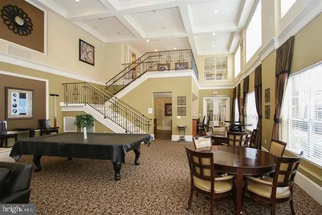 a living room with furniture a chandelier and a large window