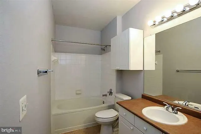 a bathroom with a sink toilet tub and shower