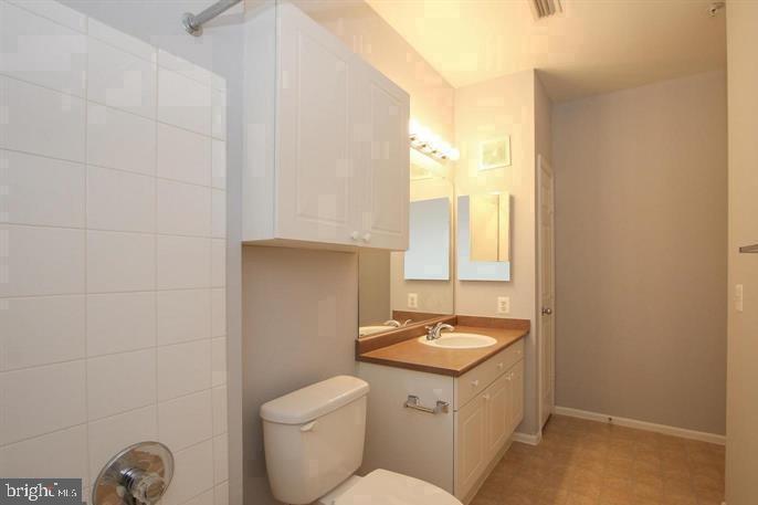 11800 Old Georgetown Road, Unit 1104 North Bethesda, MD 20852 - Photo 9 of 17 a bathroom with a sink a toilet and a window