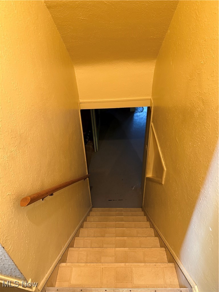 1284 Haverston Road Lyndhurst, OH 44124 - Photo 36 of 43 Staircase featuring a textured wall and a textured ceiling