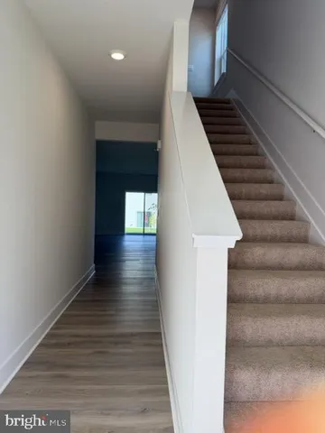 a view of entryway and hall with wooden floor