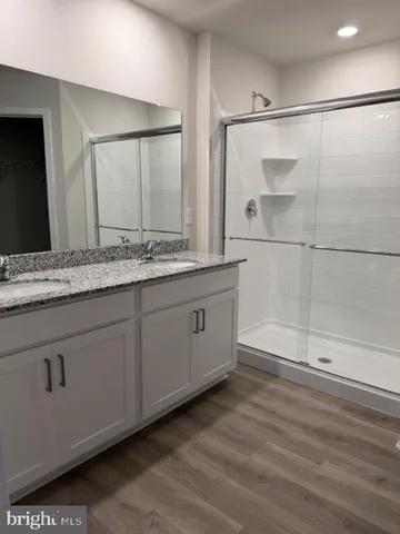 a bathroom with a granite countertop sink mirror and double