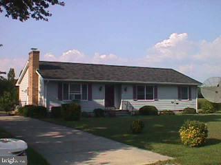 a front view of a house with a garden and a yard