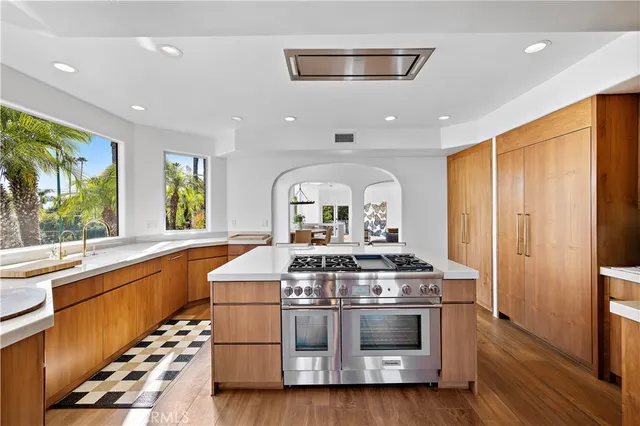 a kitchen with stainless steel appliances a stove a sink and a refrigerator