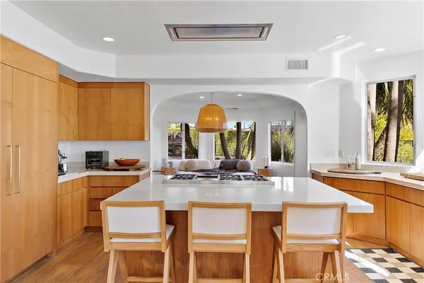 a kitchen with a stove a sink and a refrigerator