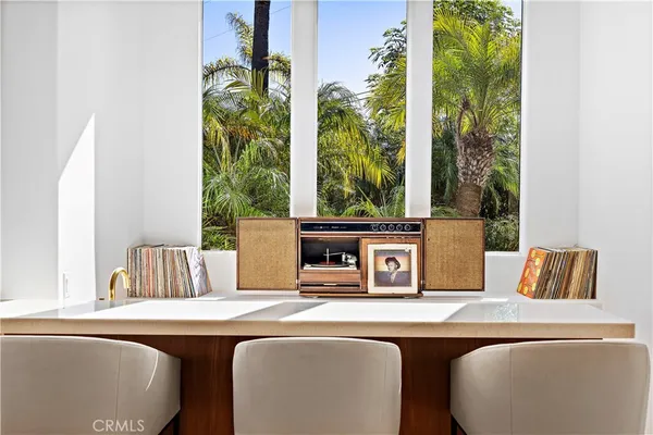 a kitchen with a dining table chairs and refrigerator