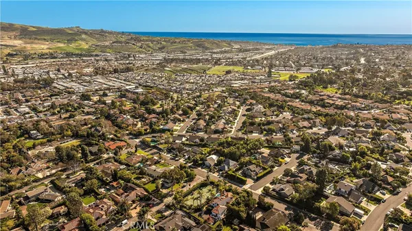 an aerial view of residential houses with ocean view