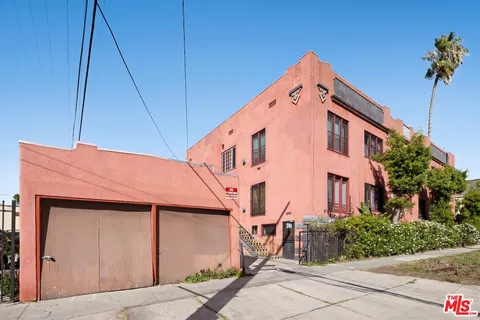 an aerial view of multiple houses with a yard