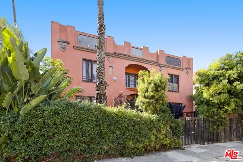 a front view of a building with glass windows and a table