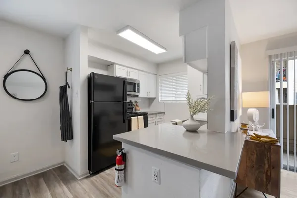 a kitchen with stainless steel appliances a refrigerator a sink a stove and island