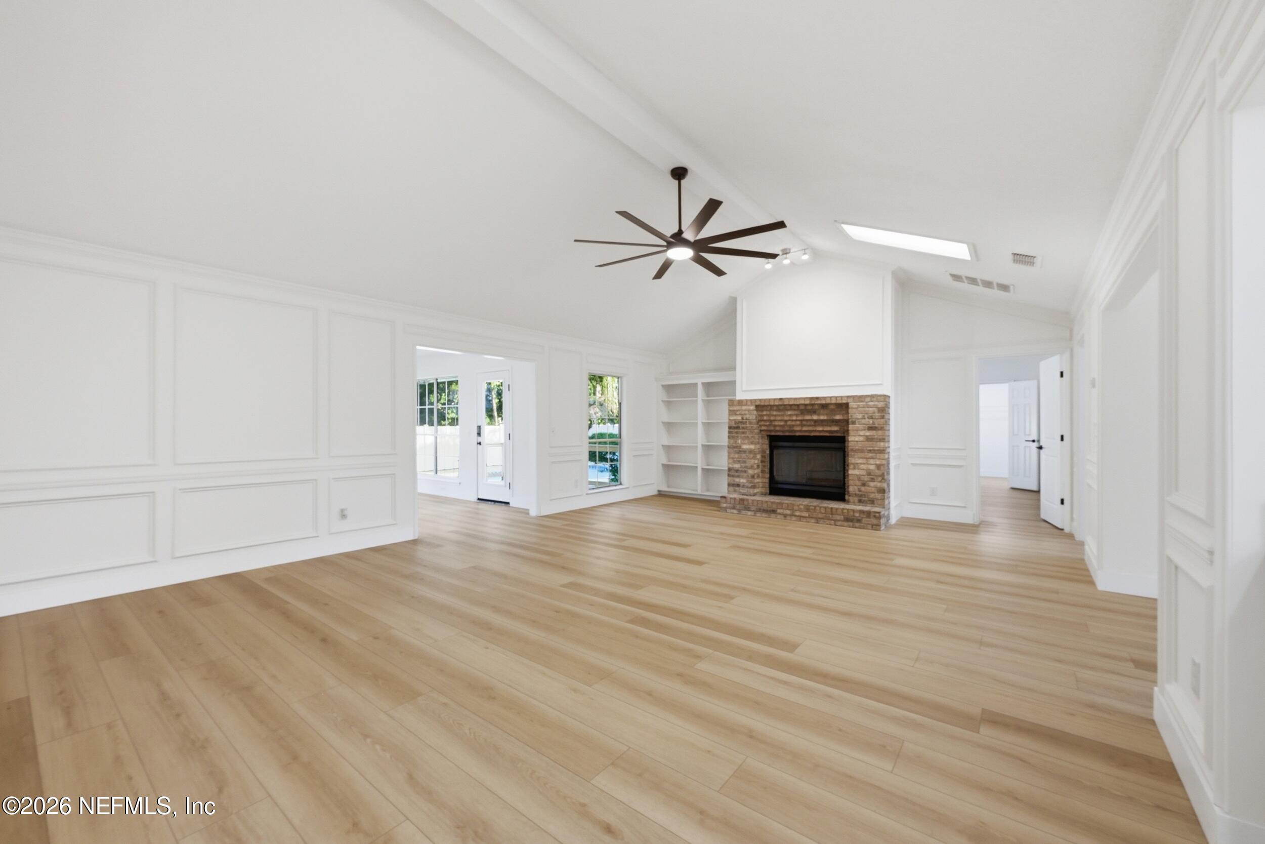 3286 Marbon Road Jacksonville, FL 32223 - Photo 7 of 36 a view of an empty room with a fireplace and a window