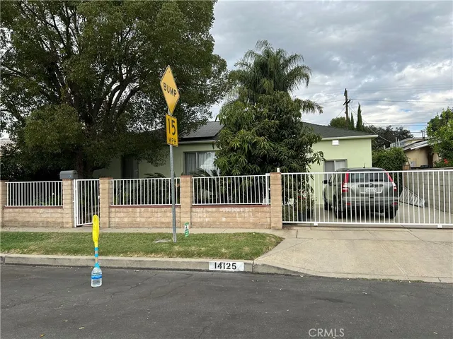 a view of a park with iron fence