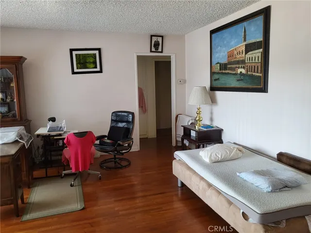 a view of a room with furniture and wooden floor