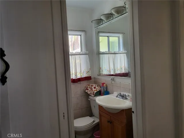 a bathroom with a sink a toilet and a window