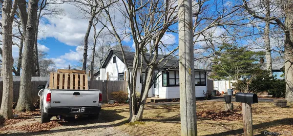 a view of a house with a yard covered in snow