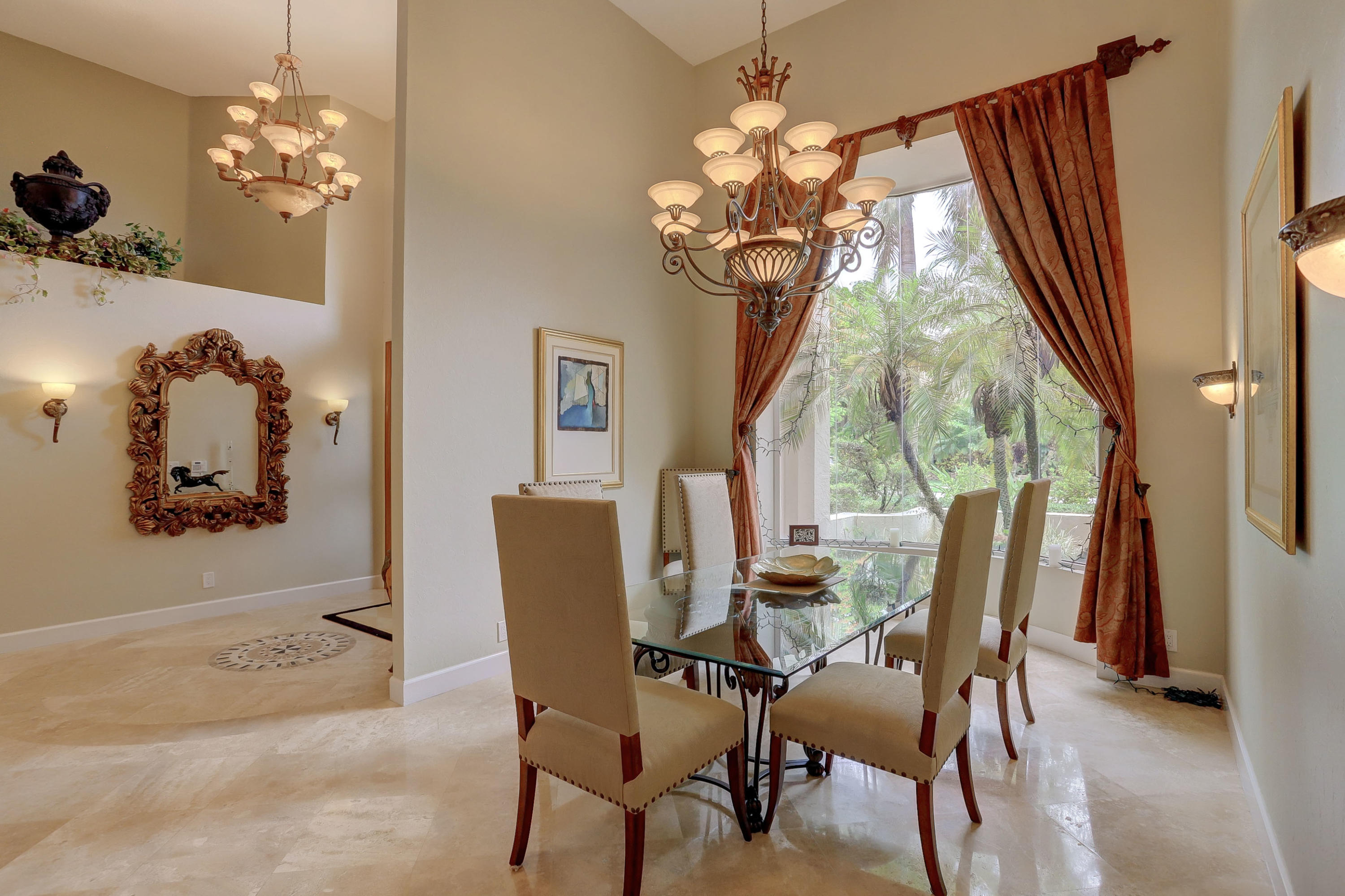 1605 Southwest 20th Avenue Boca Raton, FL 33486 - Photo 16 of 70 a view of a dining room with furniture a chandelier and large windows
