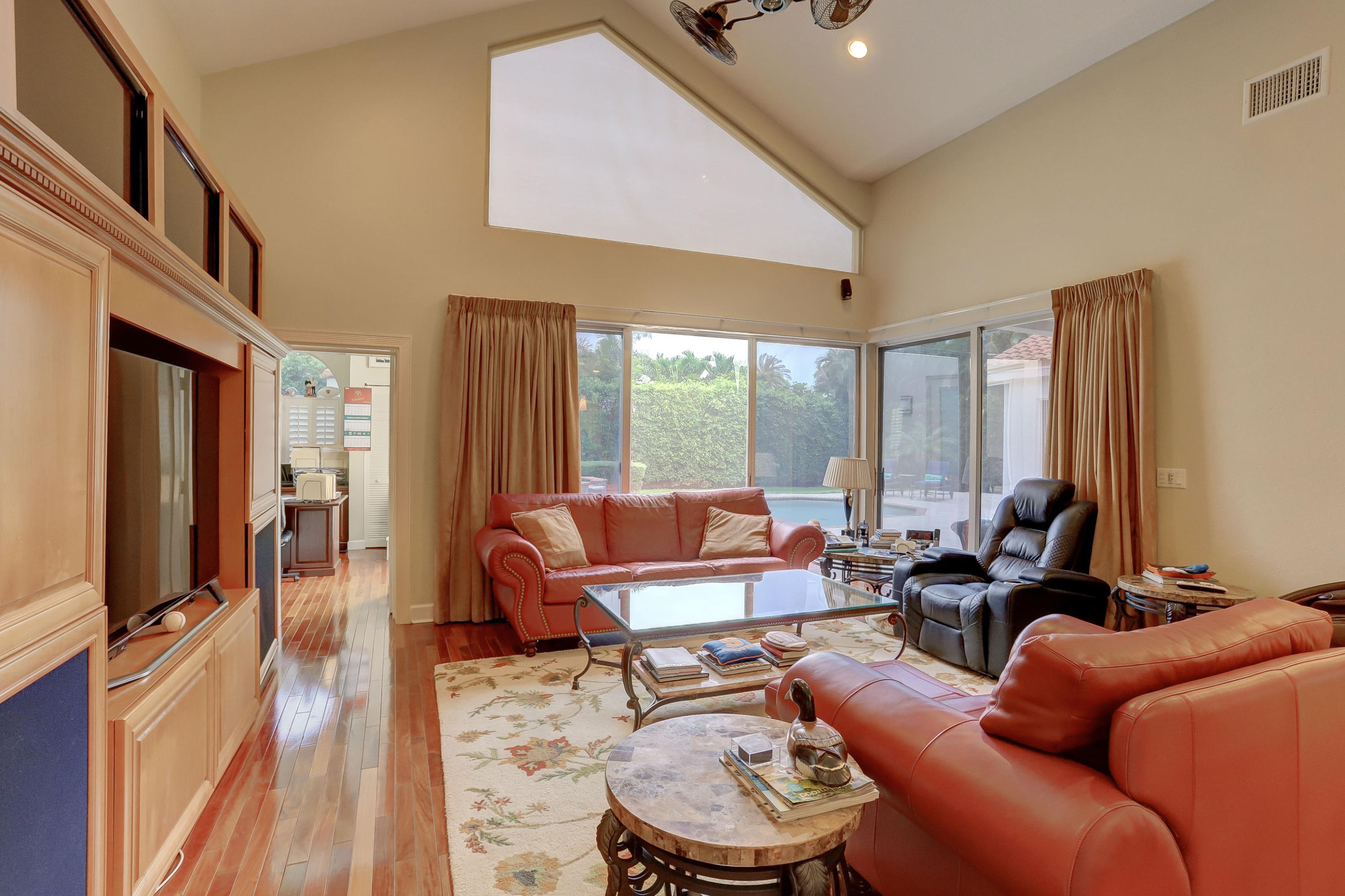 1605 Southwest 20th Avenue Boca Raton, FL 33486 - Photo 31 of 70 a living room with furniture a large window and wooden floor