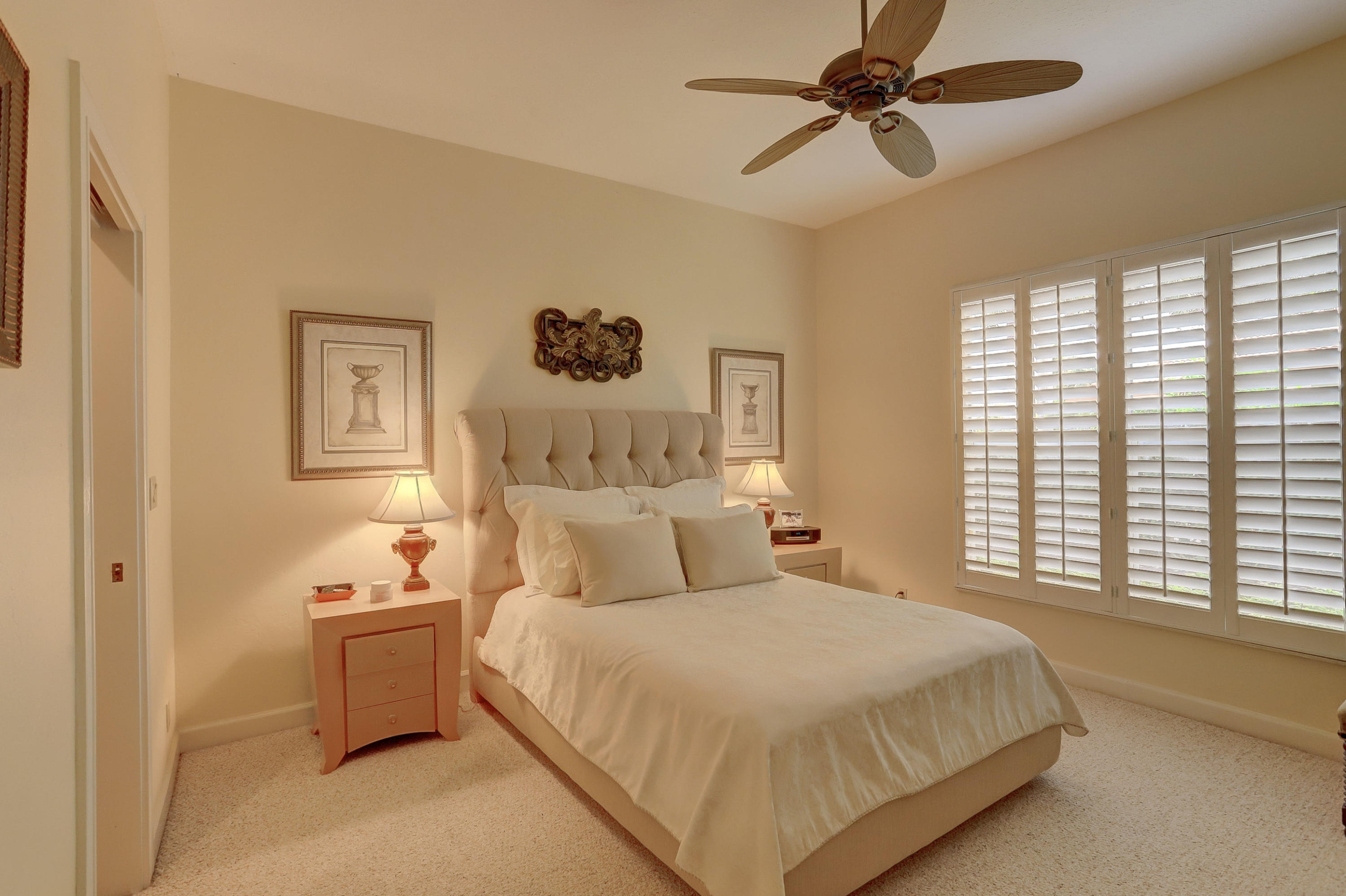 1605 Southwest 20th Avenue Boca Raton, FL 33486 - Photo 40 of 70 a bedroom with a bed and a chandelier