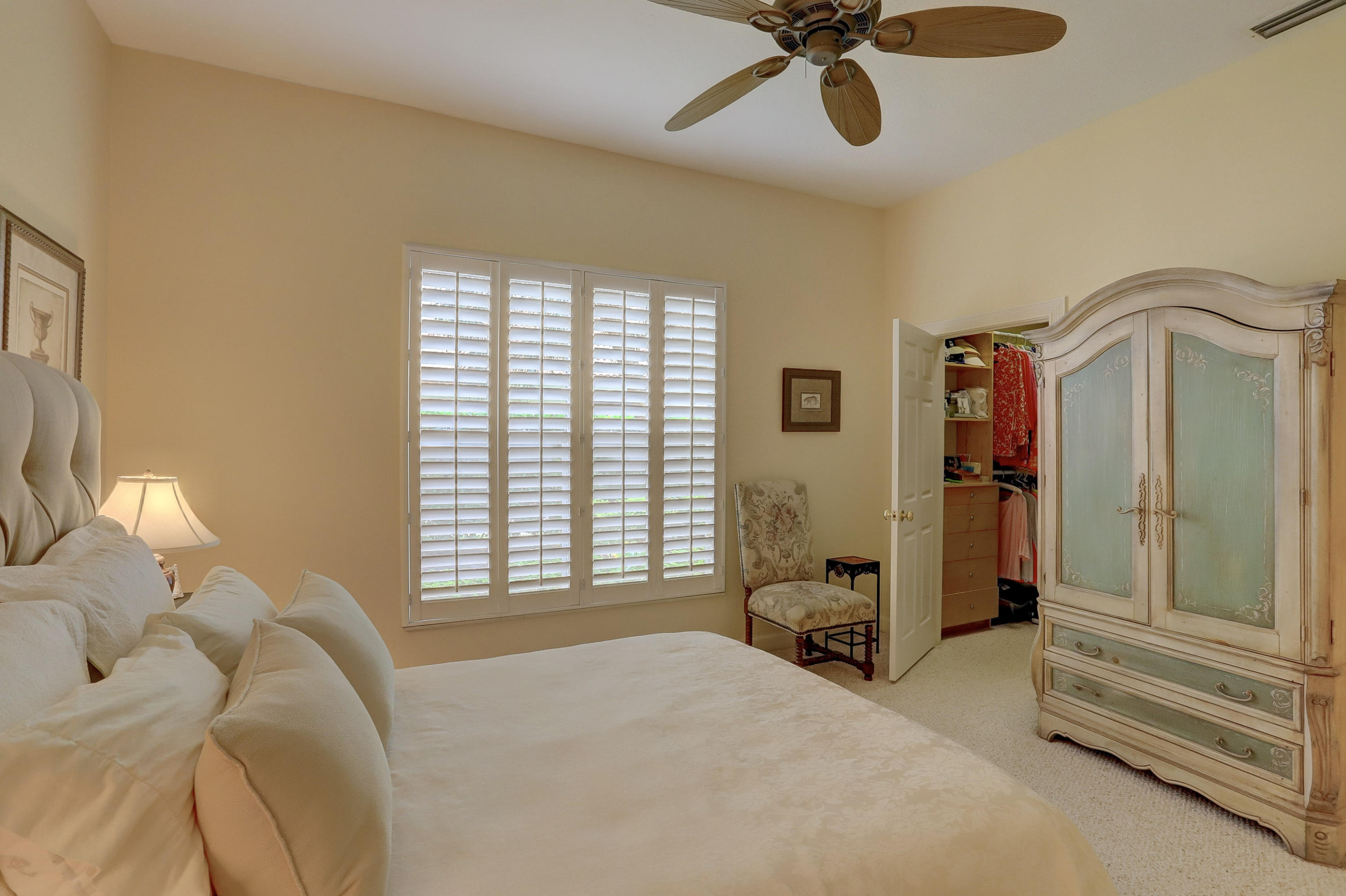 1605 Southwest 20th Avenue Boca Raton, FL 33486 - Photo 43 of 70 a bedroom with a bed and a chandelier