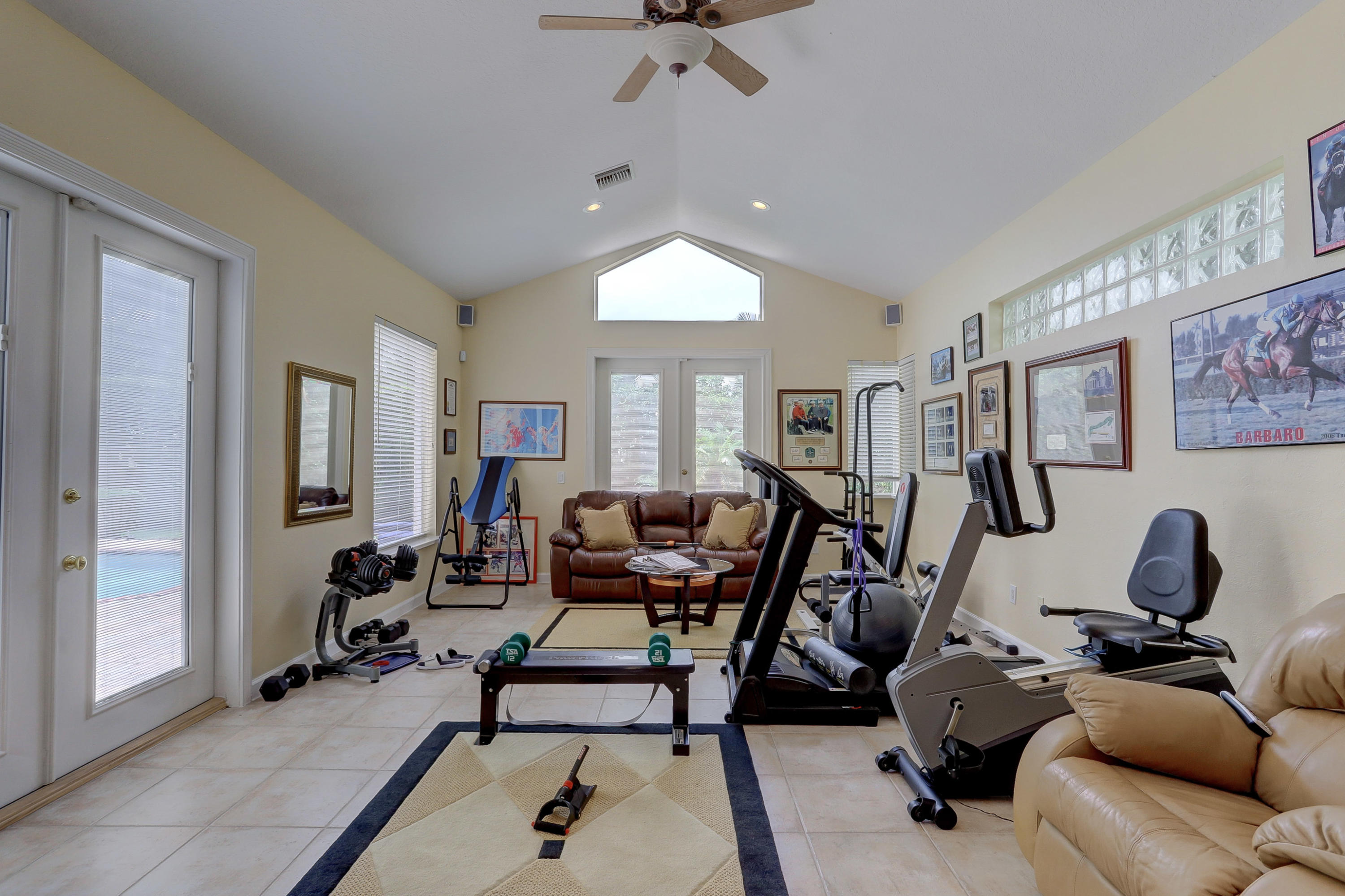 1605 Southwest 20th Avenue Boca Raton, FL 33486 - Photo 53 of 70 a living room with furniture a window and gym equipment
