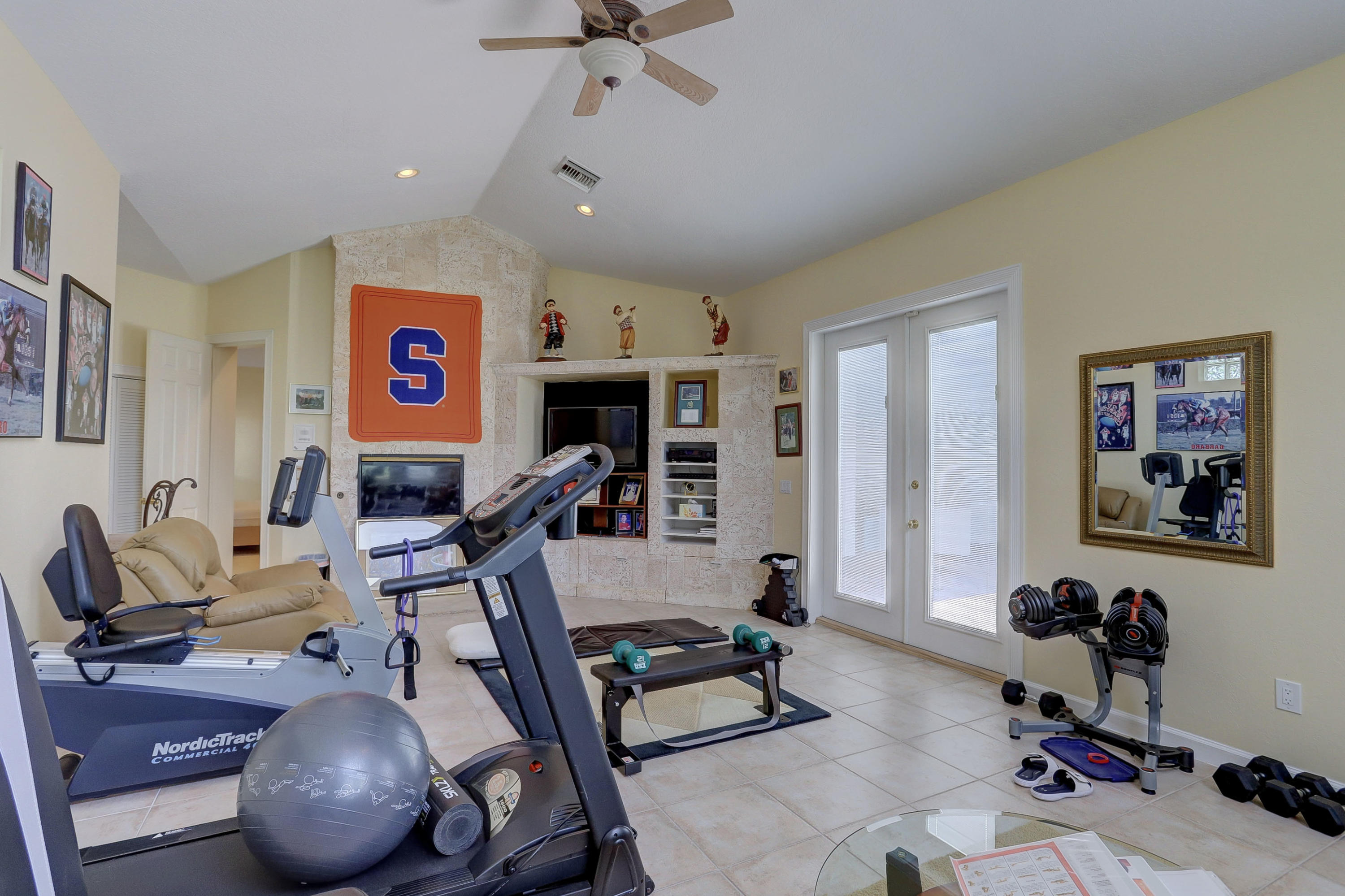 1605 Southwest 20th Avenue Boca Raton, FL 33486 - Photo 54 of 70 a work room with furniture and a flat screen tv