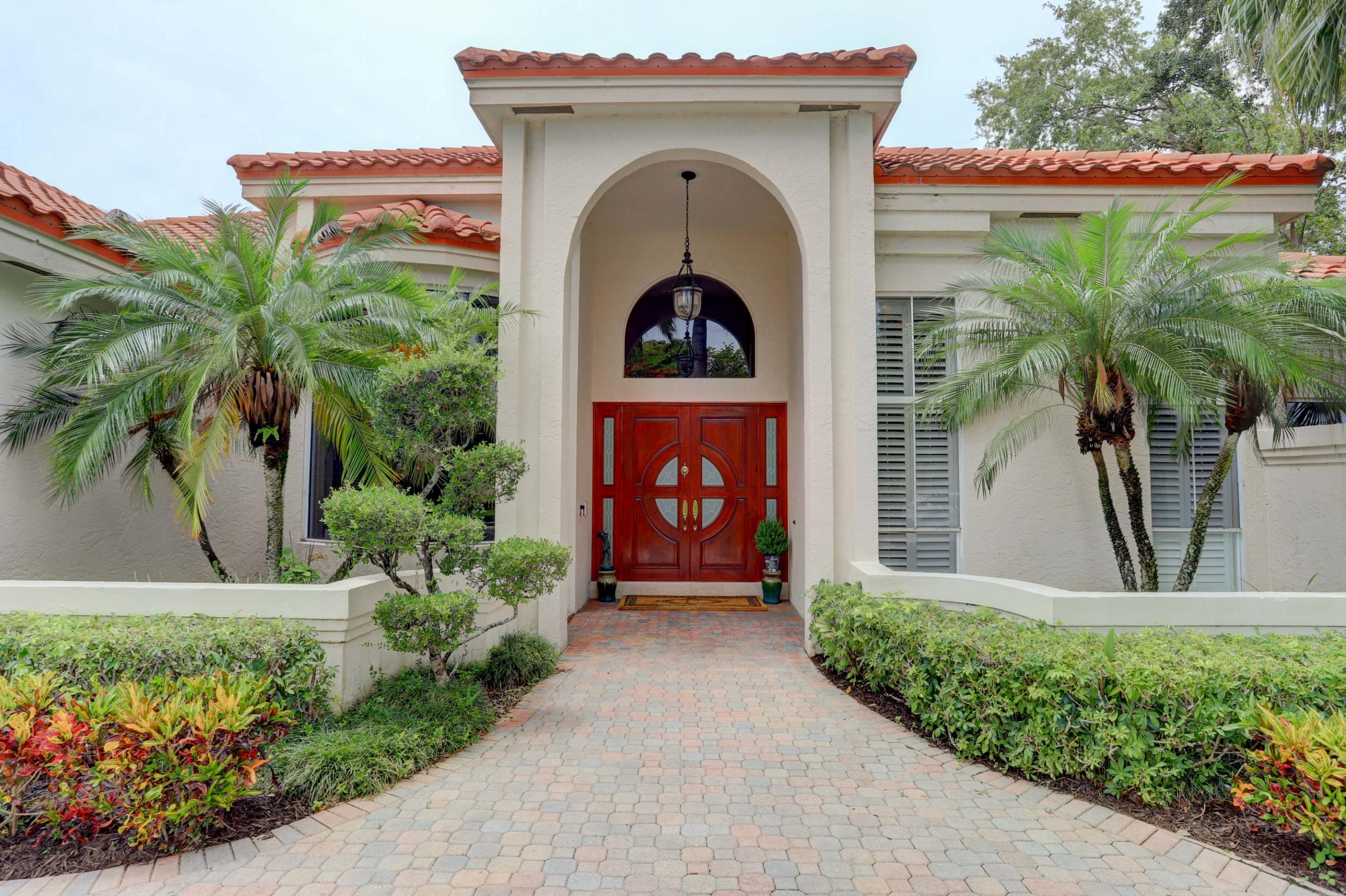 1605 Southwest 20th Avenue Boca Raton, FL 33486 - Photo 6 of 70 a front view of a house with garden