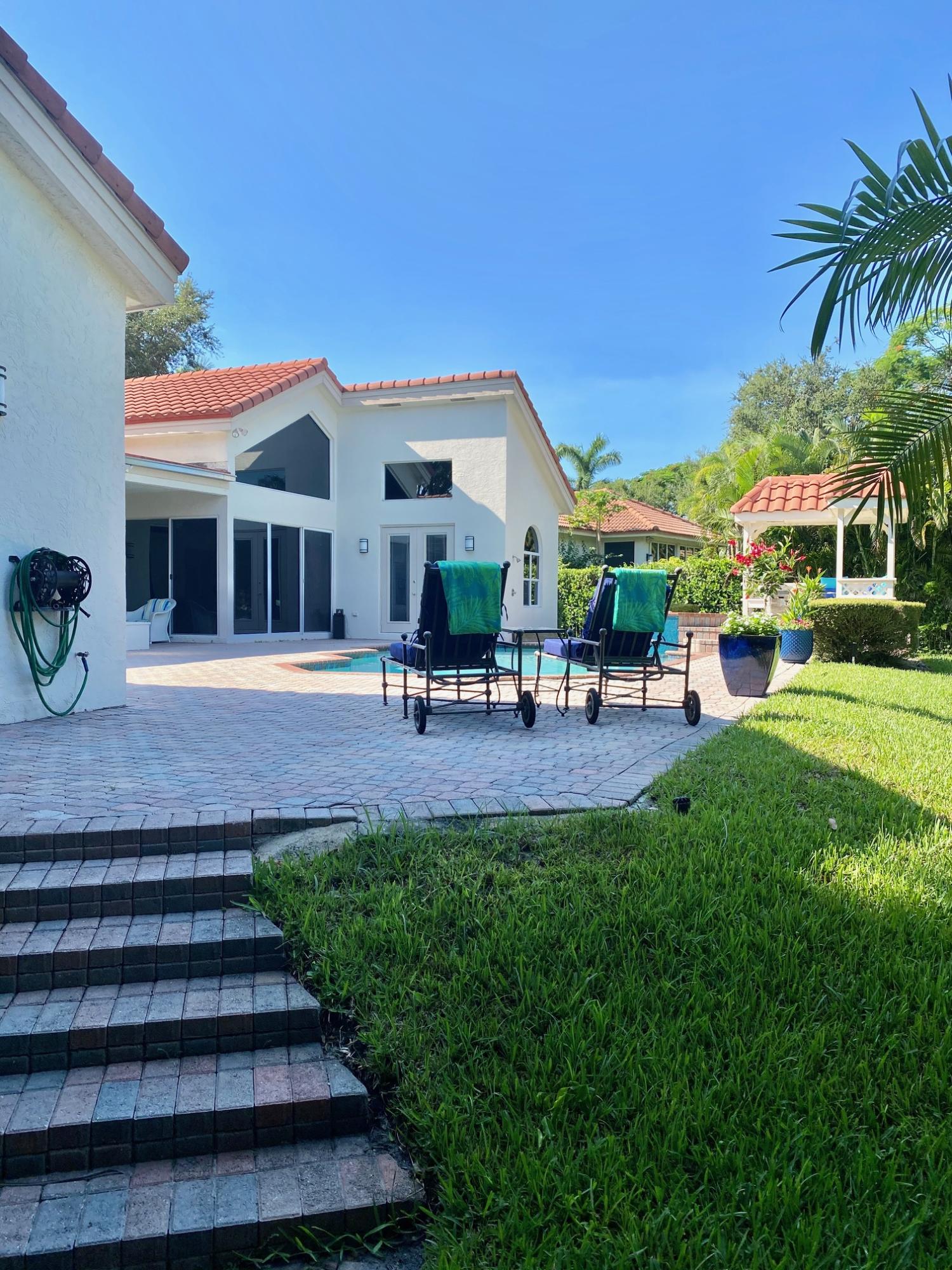 1605 Southwest 20th Avenue Boca Raton, FL 33486 - Photo 63 of 70 a group of people sitting in front of a house