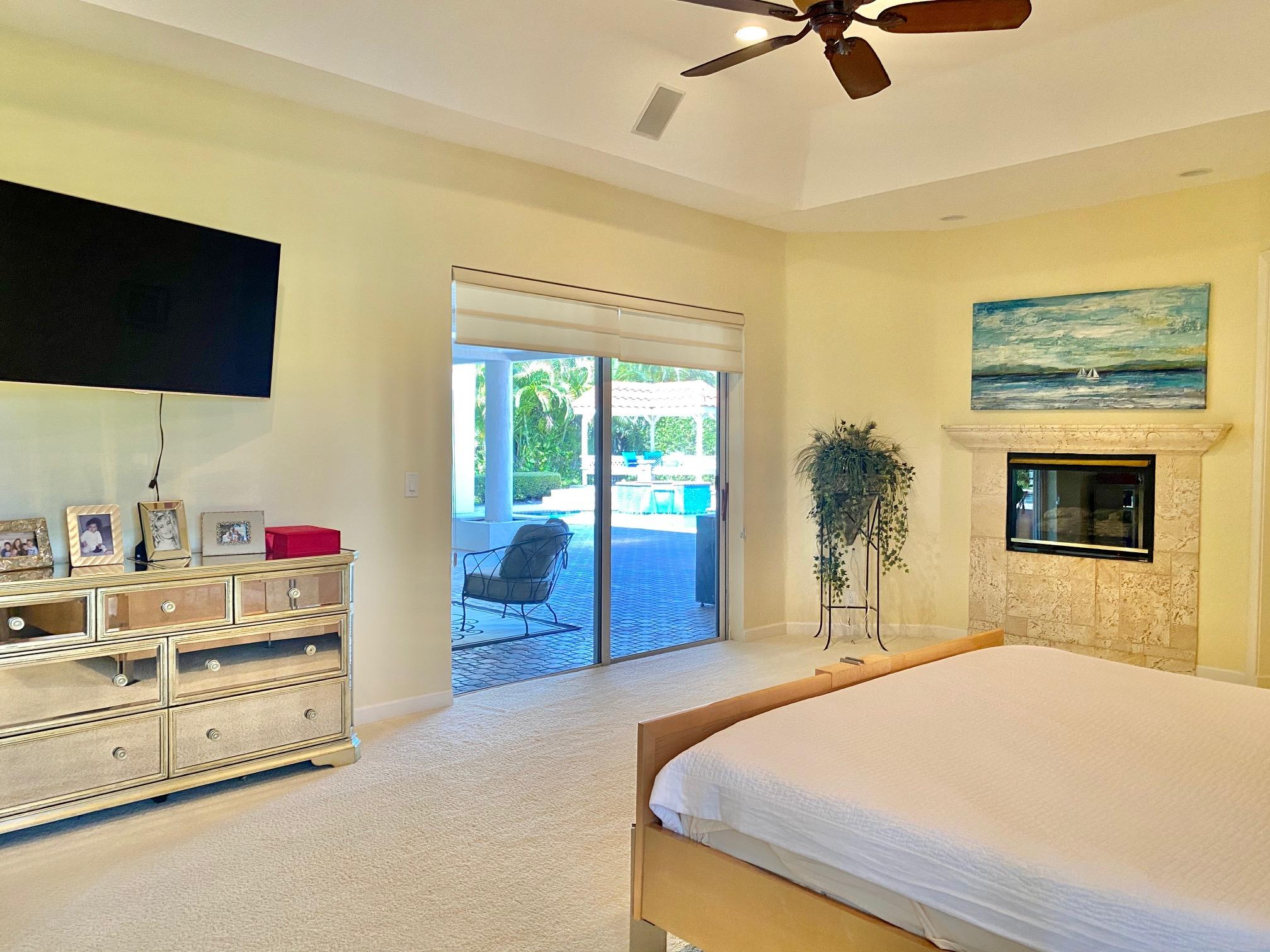1605 Southwest 20th Avenue Boca Raton, FL 33486 - Photo 8 of 70 a bedroom with a bed and a flat screen tv