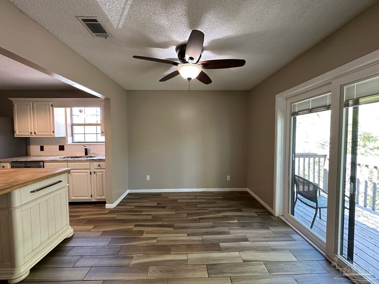 4831 East Olive Road, Unit 4D Pensacola, FL 32514 - Photo 7 of 17 a view of empty room with wooden floor and fan