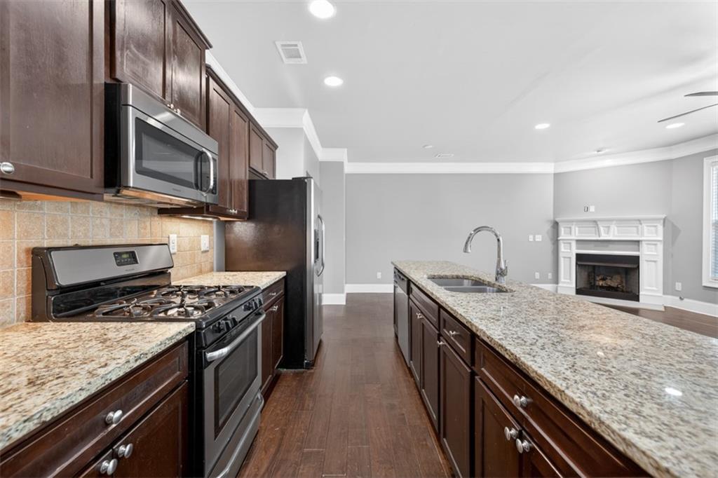 2854 Jordan Oaks Lane, Unit 8 Decatur, GA 30033 - Photo 13 of 41 a kitchen with stainless steel appliances granite countertop a sink stove and refrigerator